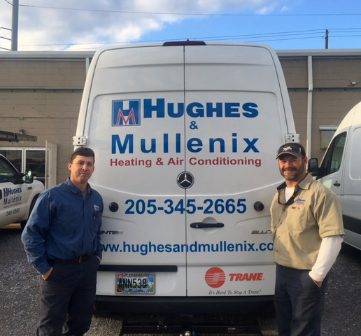 Two men with Hughes & Mullenix van